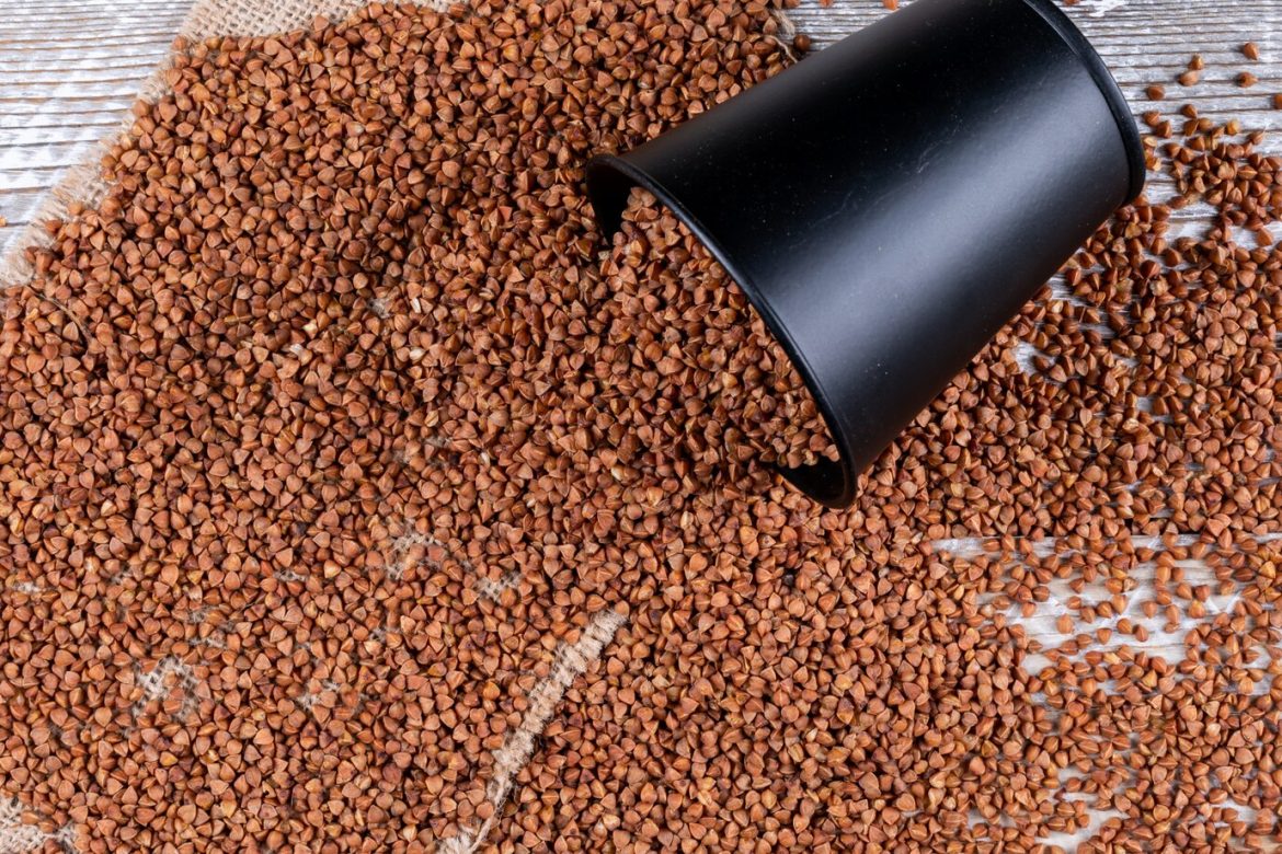 high-angle-view-buckwheats-coming-out-bucket-sack-cloth-horizontal_176474-2319